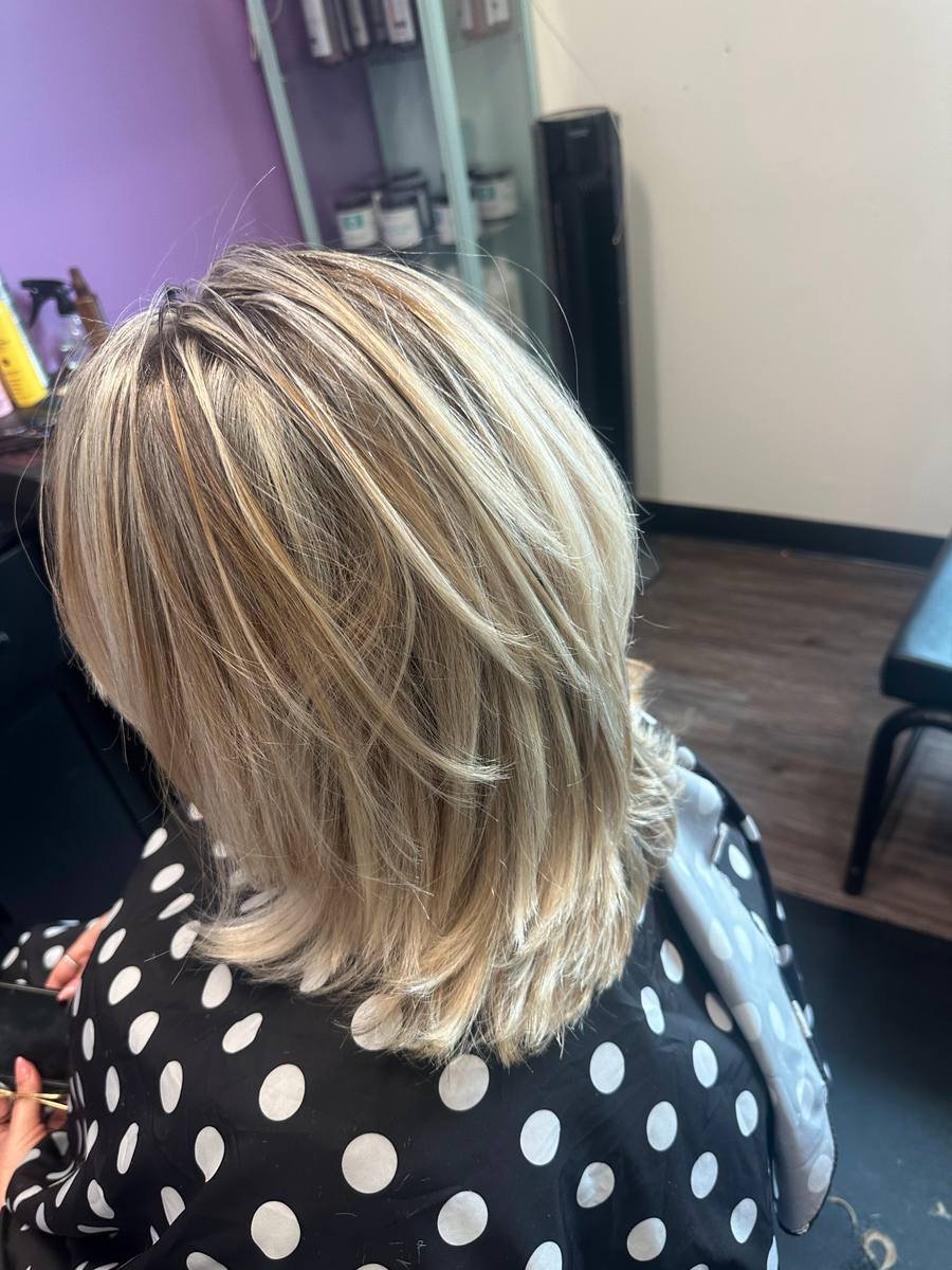 Cool blonde highlights on a layered lob with a voluminous blow-dry