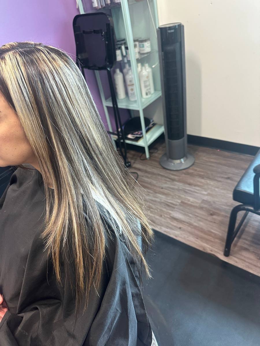 Silver-blonde highlights over dark hair, mirror-straight