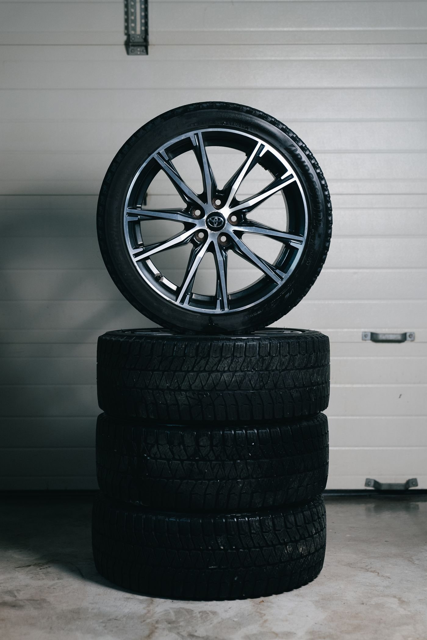 Representative photo of a stack of new tires with a mounted alloy wheel on top
