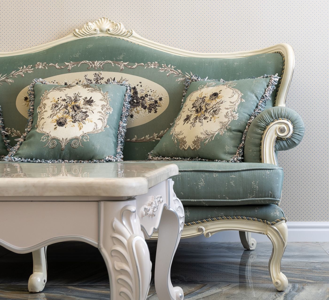 Representative photo of an ornate classic sofa reupholstered in sage-green fabric with matching cushions