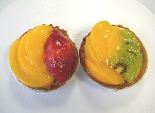 Fruit tarts topped with peach, strawberry and kiwi