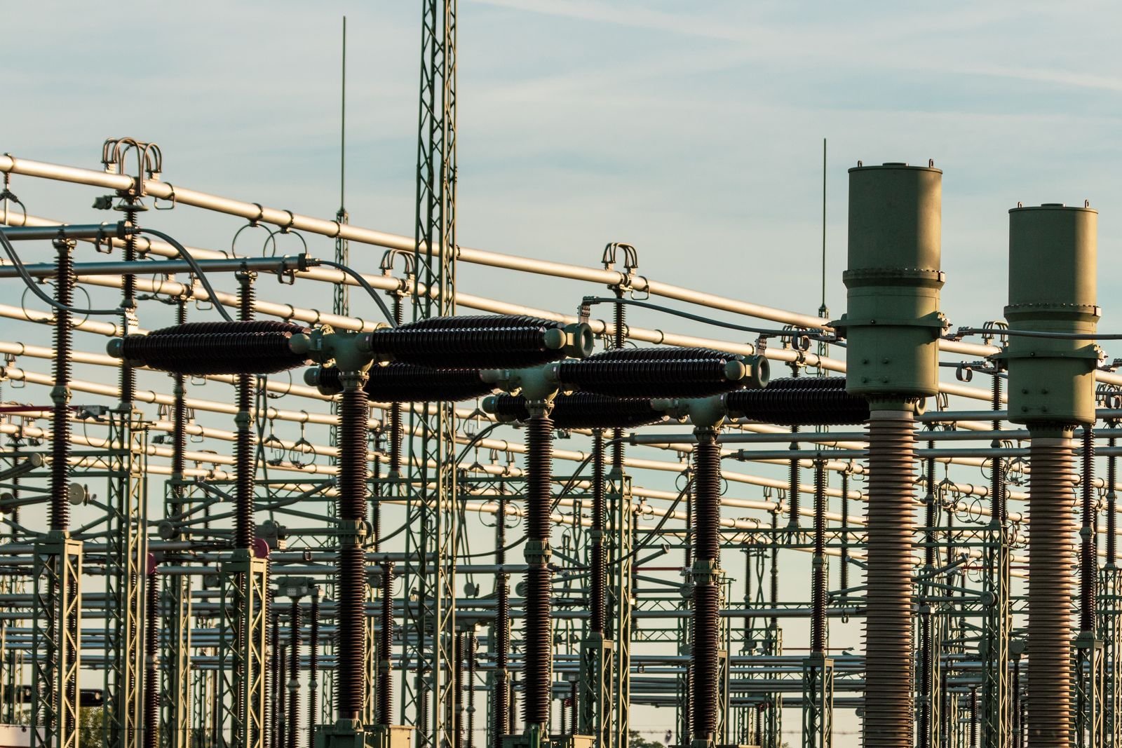 Detail of substation insulators and high-voltage equipment — the upstream feed into the plant I/O building.