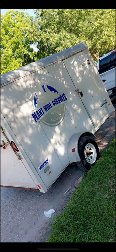 Plant Wide Services branded trailer parked at the company yard.