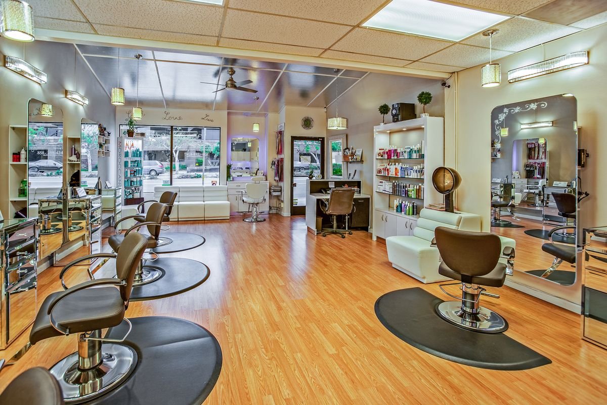Representative photo of a bright hair-salon interior with styling chairs and mirrors