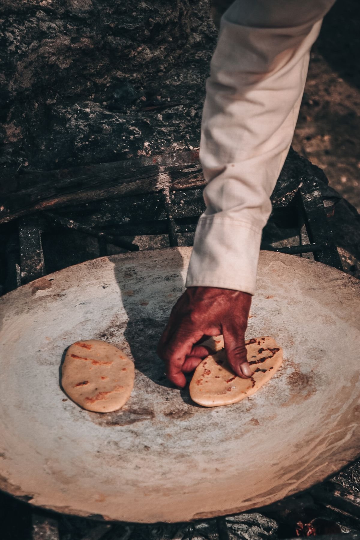 Representative photo of a handmade pupusa on the comal
