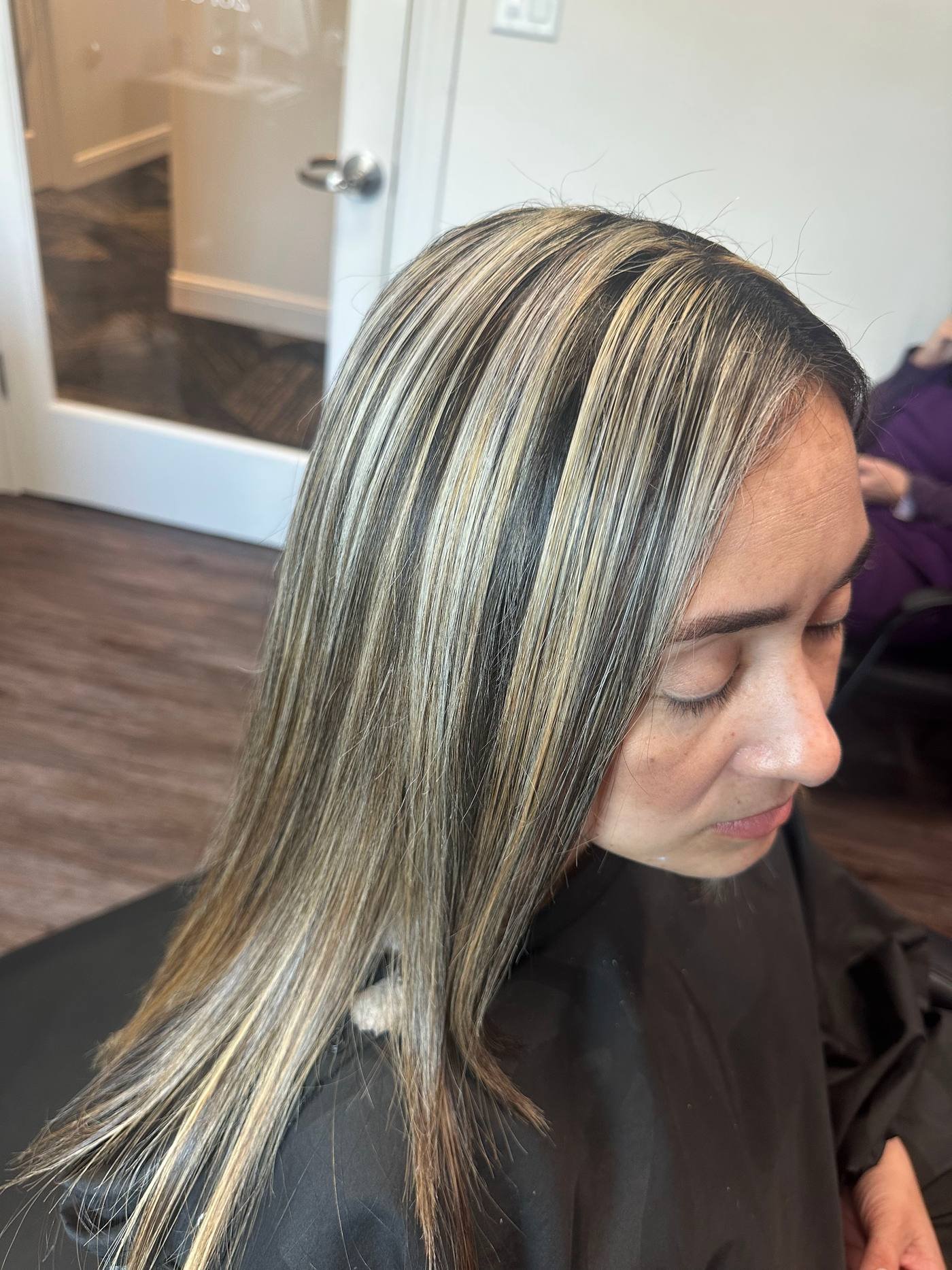 Representative photo of silver-blonde highlights on long straight hair